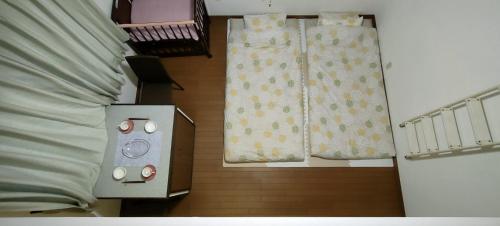 a bedroom with a bed and two curtains and a bed sidx sidx sidx at Home Stay 北国分 in Ichikawa