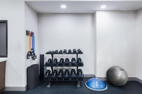 a gym room with a rack of dumbbells at Holiday Inn Express Atlanta West - Theme Park Area by IHG in Lithia Springs