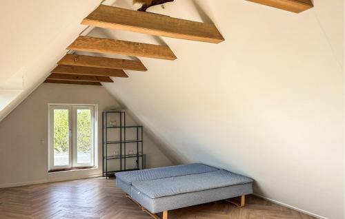 a room with a blue ottoman in the attic at Gorgeous Home In Nordborg With Kitchen in Nordborg