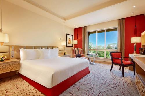 a hotel room with a bed and a large window at ITC Maratha, a Luxury Collection Hotel, Mumbai in Mumbai