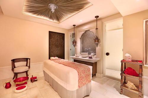 a bedroom with a bed and a table and a chair at ITC Maratha, a Luxury Collection Hotel, Mumbai in Mumbai