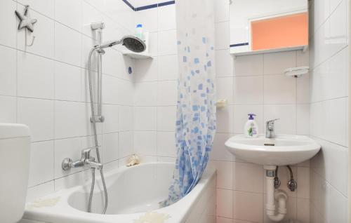 een badkamer met een douche, een wastafel en een bad bij 1 Bedroom Pet Friendly Home In Baveno in Baveno
