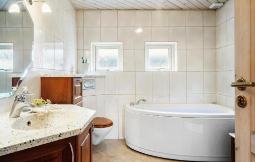 łazienka z wanną, umywalką i toaletą w obiekcie 5 Bedroom Gorgeous Home In Thyborn w mieście Thyborøn