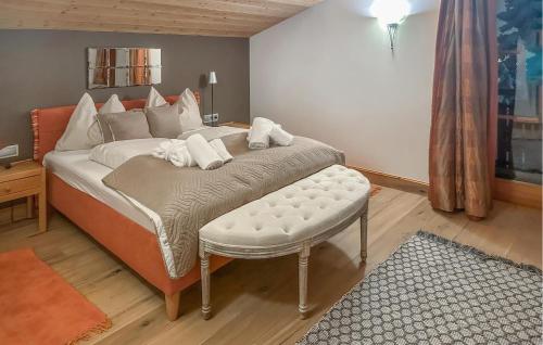 ein Schlafzimmer mit einem großen Bett mit einer Ottomane und einem Bettsenalsenal in der Unterkunft Ferienhaus Am Katschberg in Katschberghöhe