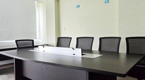 a meeting room with a table and chairs at ALTEA HOTEL - San Bartolo in San Bartolo