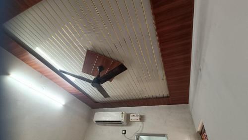 a bathroom with a ceiling with a light on it at Keshav Narayan Home Stay in Mathura