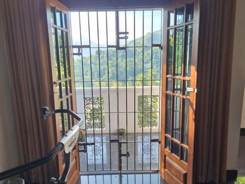 an open door to a balcony with a view at Serenity Stay in Badulla