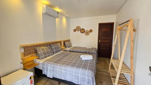 a small bedroom with a bed and a ladder at Pousada Solarium in Canoa Quebrada