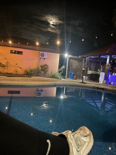 a shoe sitting in a swimming pool at night at Hotel Nacaome Blue Zone in Tapantí