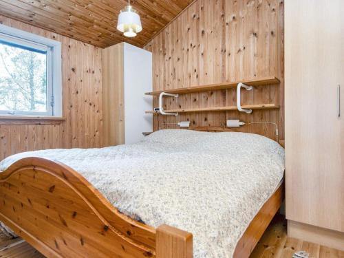 a bedroom with a bed in a wooden wall at 6 person holiday home in Struer-By Traum in Struer