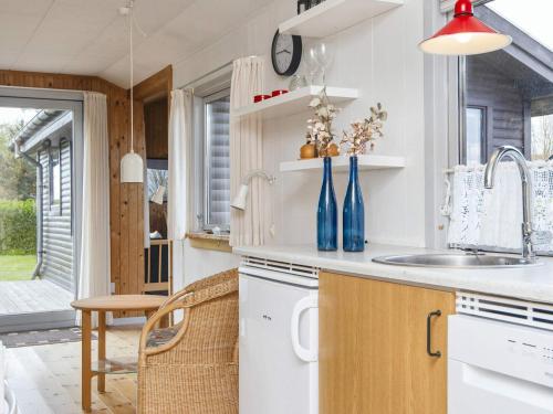 a kitchen with white cabinets and a sink at 6 person holiday home in Struer-By Traum in Struer