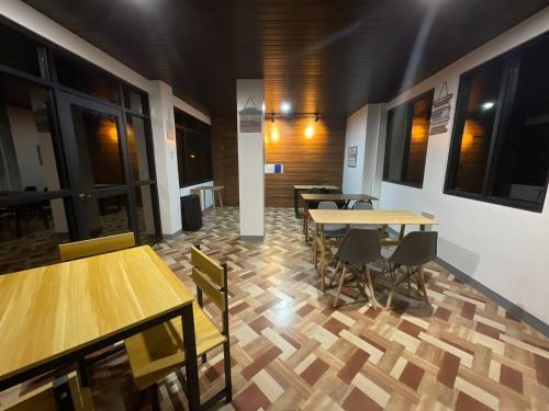 a dining room with wooden tables and chairs at Halajo bnb transient in Laoag
