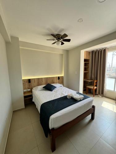 a bedroom with a bed and a ceiling fan at Hotel JOMA in San Vicente de Cañete