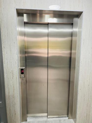 a large metal elevator door in a building at Happy Dreams Oasis Cazin, Modernes Apartment 60m2, WiFi & Balkon in Cazin
