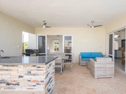 a living room with a stone wall and a living room at Caribbean Paradise Villa - 3 bed, 3 Bath and Pool in Sosúa