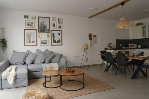 a living room with a couch and a table at HaKerem new luxury 3 rooms apartments and 2 rooms penthaus in Tel Aviv