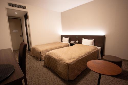 Postel nebo postele na pokoji v ubytování Hotel Aisul Matsuyama