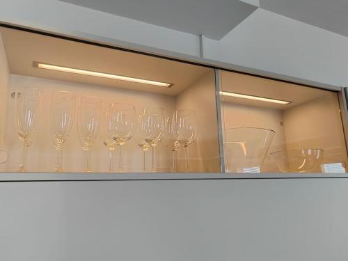 a row of wine glasses sitting on a shelf at Keskustan tyylikkäin studio in Lappeenranta
