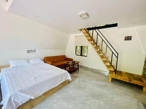 a bedroom with a bed and a spiral staircase at HOLY VILLA A Frame 3beds 1sofa bed 1bathroom in Kampot
