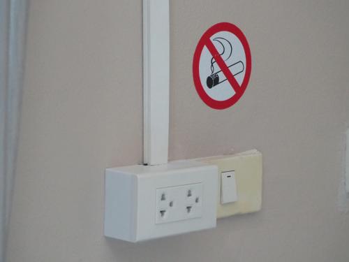 a no music sign on a wall next to an outlet at บ้านชมเขา - Baan Chom Khao in Pak Chong
