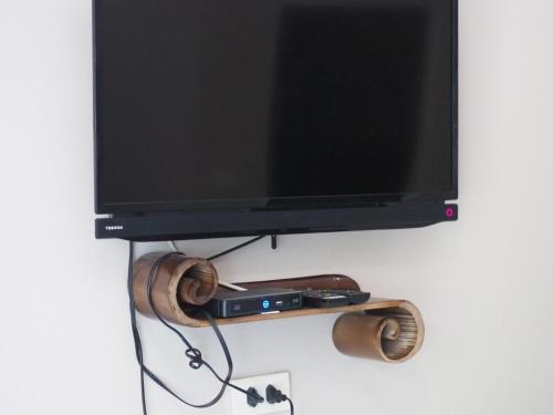 a flat screen tv hanging on a wall at บ้านชมเขา - Baan Chom Khao in Pak Chong