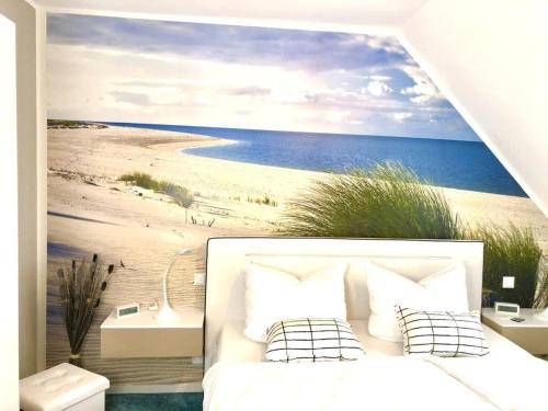 a bedroom with a mural of a beach at Seaside 2 Modern retreat in Prerow