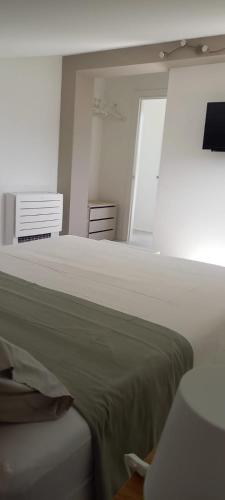 a white bedroom with a bed and a window at I Secolari di Giulia in Avola