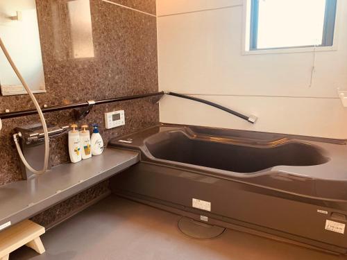 a bathroom with a bath tub and a sink at 道龍house in Azagawa