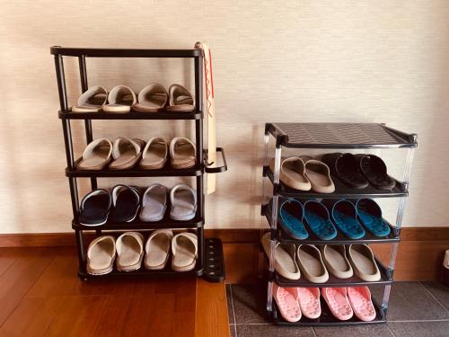 a rack of shoes sitting next to a wall at 道龍house in Azagawa