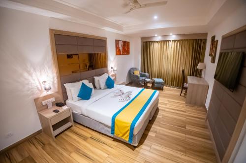 a hotel room with a bed and a living room at Arcadia Hotel in Varanasi
