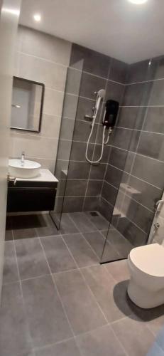 a bathroom with a shower and a toilet and a sink at Non Smoking Theda Antara Putrajaya with Wifi and Netflix in Putrajaya