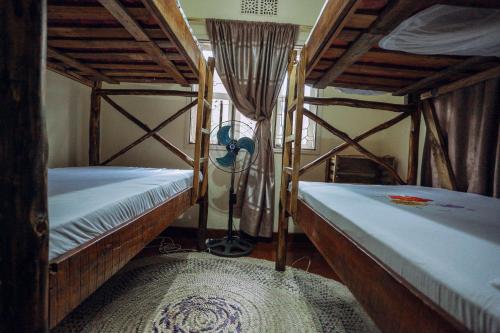 a room with two bunk beds in a room at Janibichi Adventures hostel in Moshi