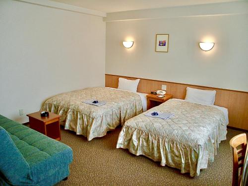 Postel nebo postele na pokoji v ubytování Matsue Universal Hotel