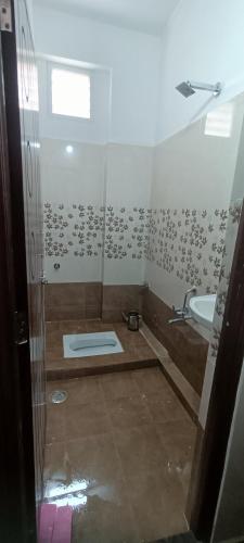 a bathroom with a shower and a sink at Ruqaiyah Manzil in Hyderabad