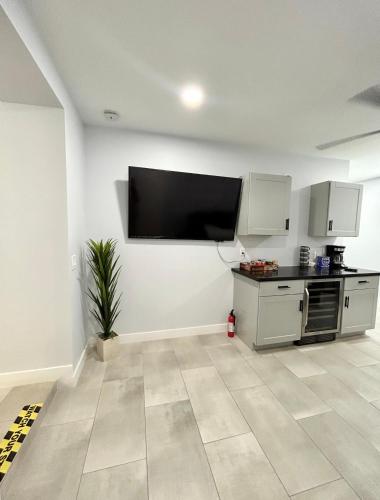 a kitchen with a flat screen tv on a wall at NEW! Private Lux Home Near Airport, Affordable AZ in Phoenix