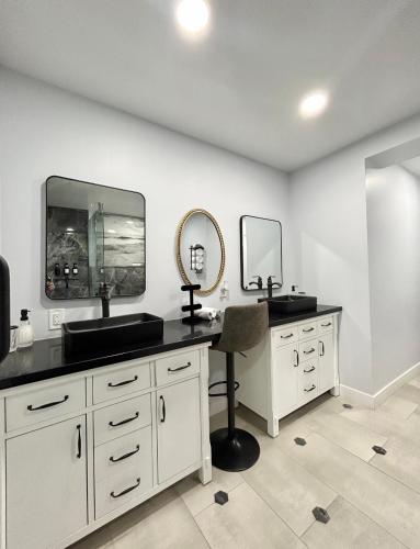 a bathroom with a vanity with a sink and mirrors at NEW! Private Lux Home Near Airport, Affordable AZ in Phoenix