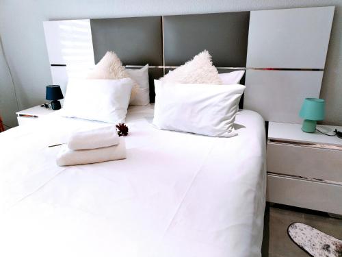 a bedroom with two beds with white sheets and pillows at Reutlwane Gardens house in Secunda