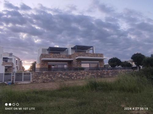 a house on top of a stone wall at Molineux Luxury Nikiti in Nikiti