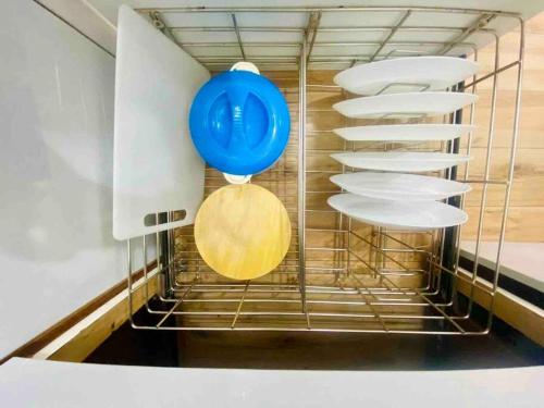 a blue balloon and plates in a dishwasher at Saba 201 Charming 3 Bedrooms 2 Bathrooms Apartment in Bandra West with Balcony by Connekt Homes in Mumbai