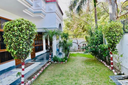 a house with a garden in front of it at Madhuraj Hotels in Noida