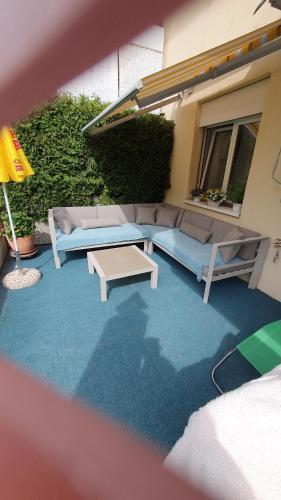 a patio with a couch and a coffee table at Haus Sarah in Brigerbad