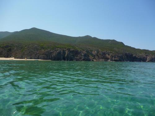 a view from the water of a beach at Casa vacanze con terrazza panoramica vista mare in Portu Maga