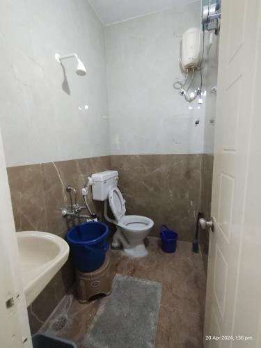 a bathroom with a toilet and a tub and a sink at GM Comforts -LODGE-CL-7 in Bangalore