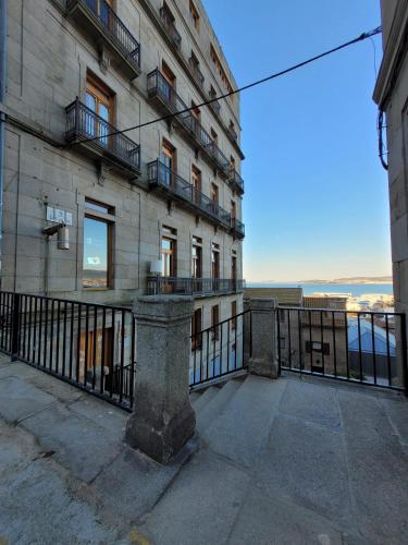 a building with a fence in front of it at Casa Mama in Vigo