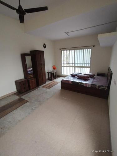 a large bedroom with a large bed and a window at GM Comforts -LODGE-CL-7 in Bangalore
