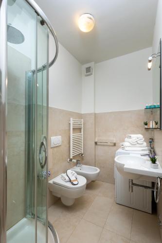 a bathroom with a shower and a toilet and a sink at Artis Appartamento in Rimini