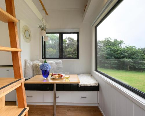 a tiny house with a table and a window at Tiny Nest in Woonona