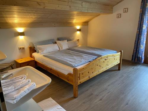 a bedroom with a large bed with a bath tub at Zum Bergbauer in Mittenwald