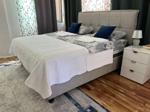 a bedroom with a large bed with blue pillows at Apartman Glorija in Kotor
