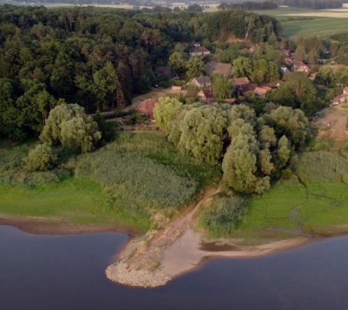 an island in the middle of a body of water at Natur Kunst Ferienhaus in Neu Darchau